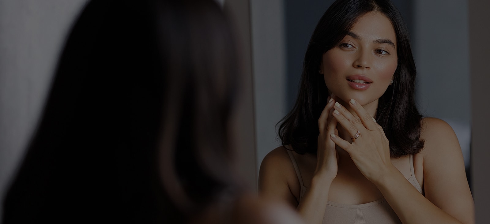 Woman admiring herself in a mirror.