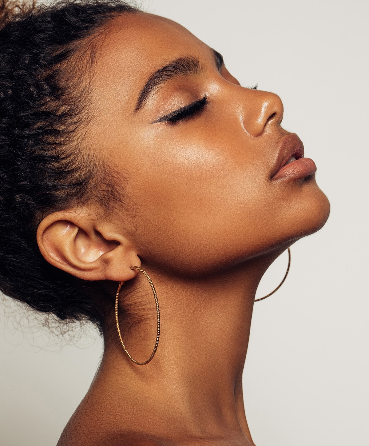 Profile of a woman with hoop earrings.