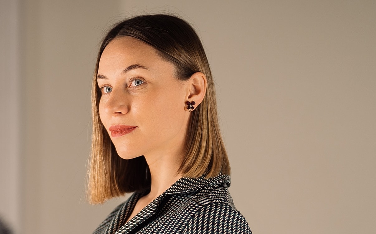 Woman with short hair and stylish earrings.