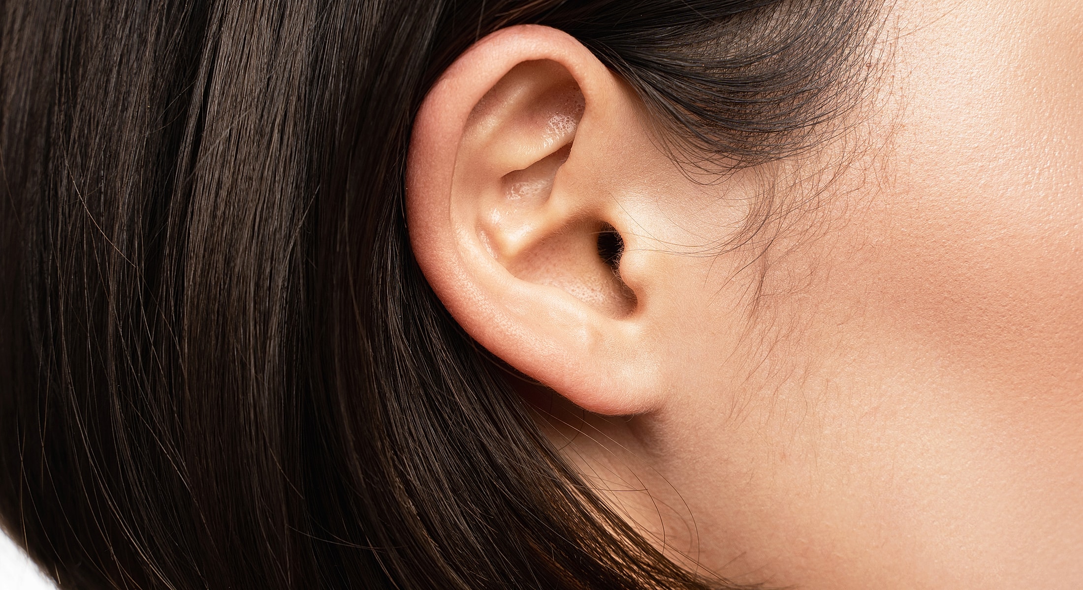 Close-up of a human ear and hair.