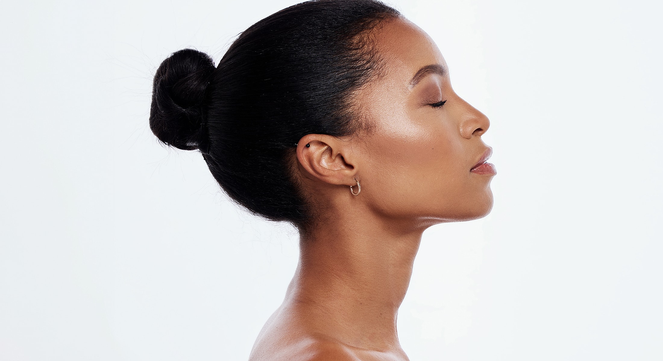 Profile of a woman with a sleek bun.